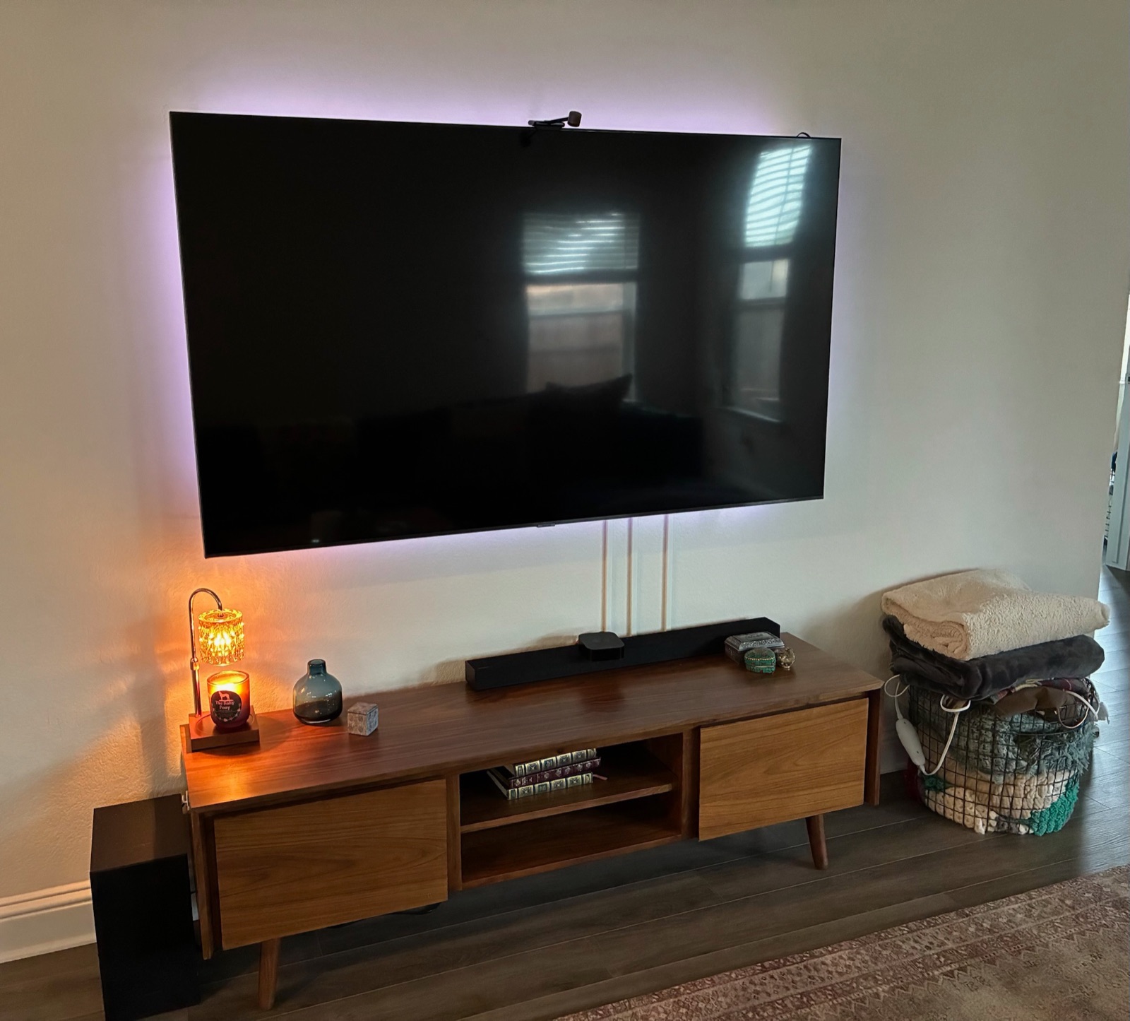 Wall-mounted TV with concealed cords and color LED backlighting