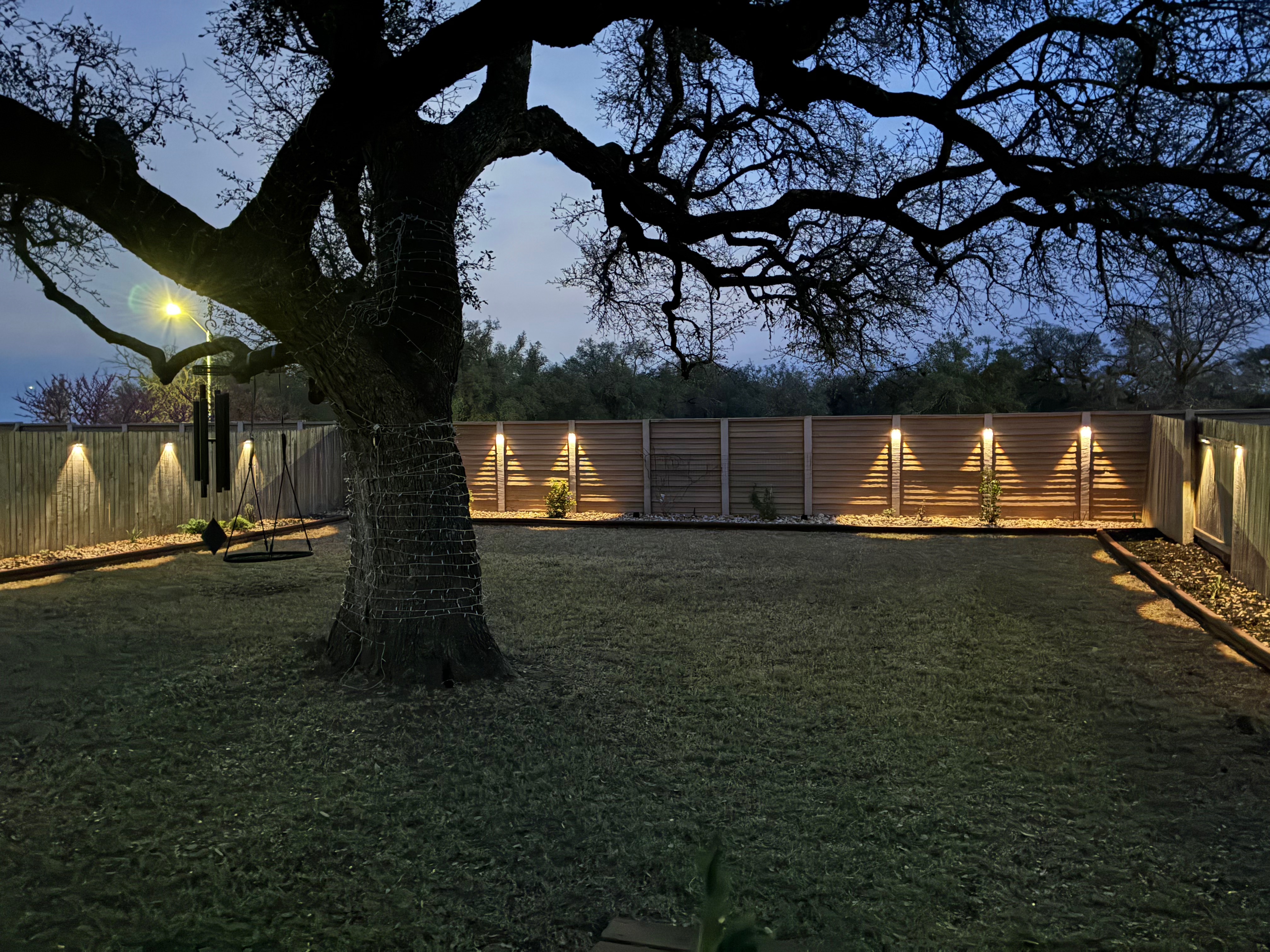 Beautiful backyard lighting installation at dusk in Austin, Texas